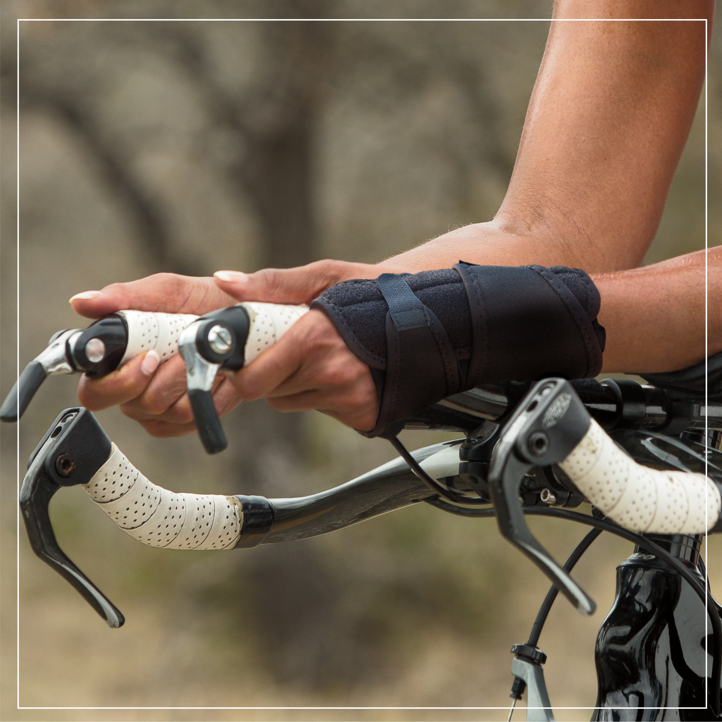 example of hand holding bike bars with brace on