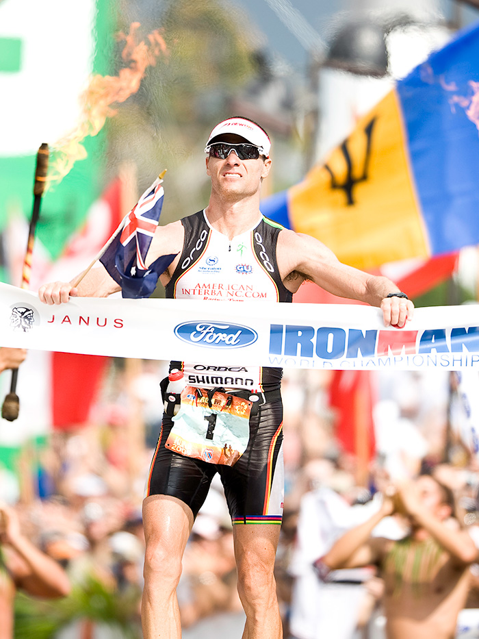 Man crossing the finish line at an Ironman